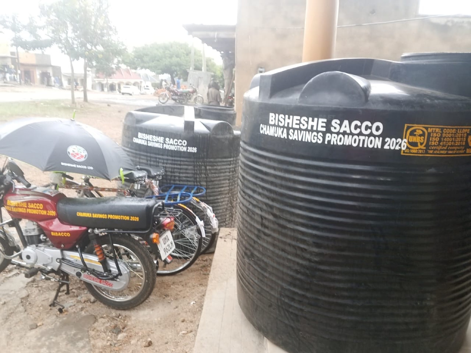 Bisheshe SACCO savings promotion rewards including a motorcycle and water tanks